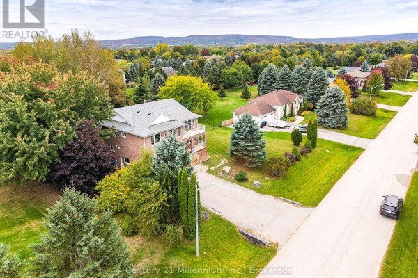 Front elevation of 46 Donald Avenue, a brick house with a white-trimmed roof, double garage, and a front balcony. - 46 Donald Avenue, Clearview
