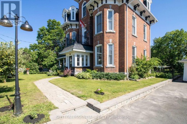 Stone pathway leading to the side of a red brick heritage home with a large lamp post. - 46 Quabbin Road, Front Of Yonge