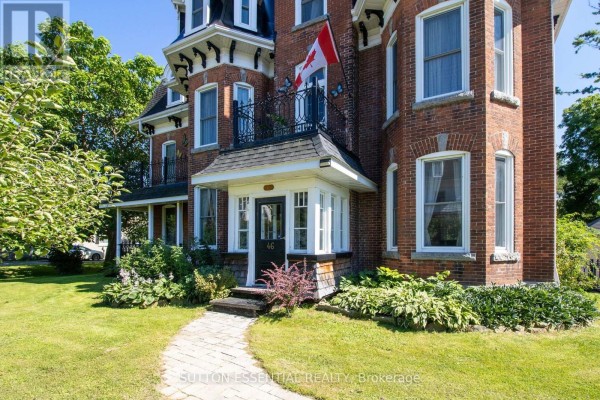 Entrance to a red brick home at 46 Quabbin Road with a covered porch and Canadian flag. - 46 Quabbin Road, Front Of Yonge