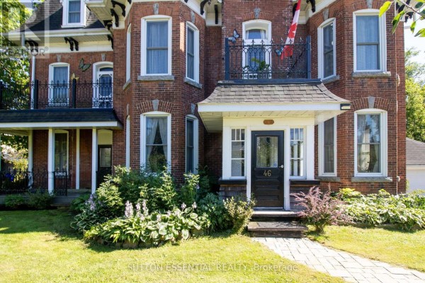 Front entrance of a red brick Victorian home with multiple windows and decorative balconies. - 46 Quabbin Road, Front Of Yonge