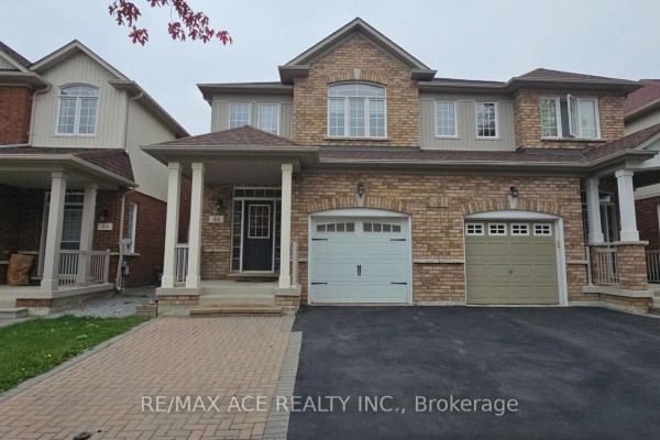 Close-up front view of a stone and brick townhouse with a double garage. - 46 Ralph Chalmers Avenue, Markham