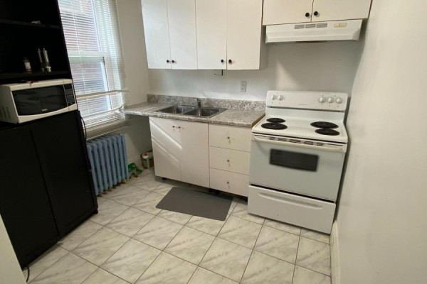 Kitchen with white cabinets, granite countertops, double sink, and white appliances. - Main Floor - 46 Rockcliffe Boulevard, Toronto