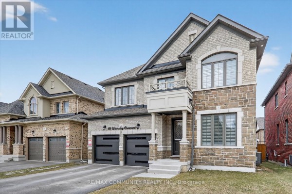 Entrance with a decorative door, stone accents, and a welcome mat. - 46 Wamsley Crescent, Clarington
