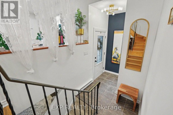 Interior staircase and foyer with white railings, dark wall, and a mirror. - 46 Westcliffe Street, Ottawa
