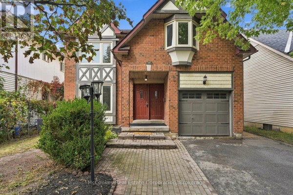 Front exterior of a two-story brick house with a covered entrance. - 460 Cardinal Drive, Peterborough