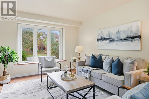 Living room with a sofa, chairs, coffee table, and a large window. - 460 Cardinal Drive, Peterborough