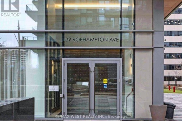 Building entrance of 39 Roehampton Avenue with glass doors and signage. - 4603 - 39 Roehampton Avenue, Toronto