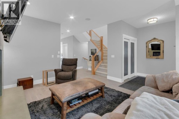 Interior entryway with a white door, grey walls, and a dark rug. - 4616 82 Street Nw, Calgary