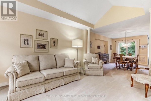 A spacious bedroom with carpeted floors and large wooden furniture. - 462 Ambleside Drive, London North