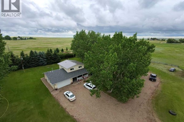 Aerial view of a long driveway leading to a house and garage on a rural property with surrounding fields. - 463, 181043 Hwy 550, Rural Newell, County Of