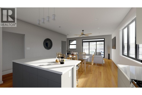 Side exterior view of the townhouse complex with garages and elevated balconies. - 463 Wade Avenue Unit# 104, Penticton