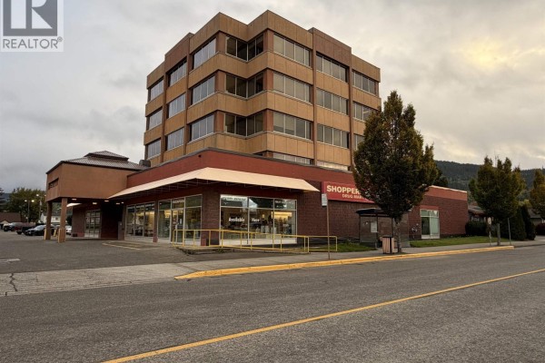 Exterior view of the commercial building with multiple storefronts and large windows. - 4634 Park Avenue, Terrace