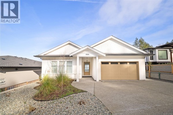 Modern bathroom with white cabinetry and large mirror - 4646 Ambience Dr, Nanaimo