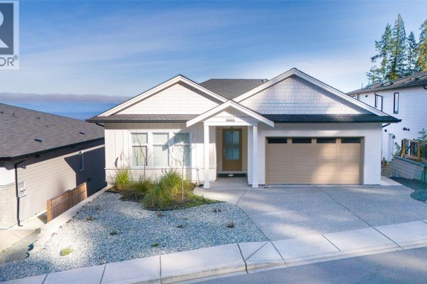 Exterior view of the house with a deck and landscaped yard - 4646 Ambience Dr, Nanaimo