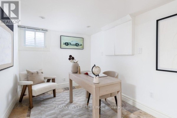 Office with desk, armchair, and car artwork - 4653 Dundas Street W Toronto