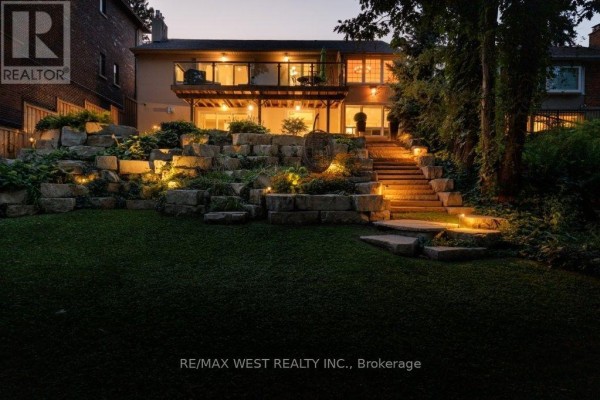 Tiered stone wall with lighting, deck, and steps - 4653 Dundas Street W Toronto