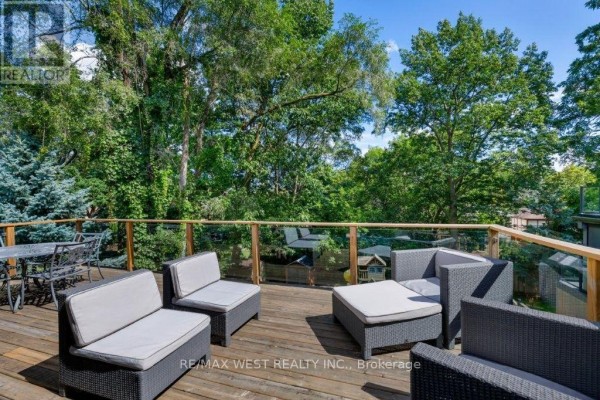 Deck with outdoor furniture and glass railing - 4653 Dundas Street W Toronto
