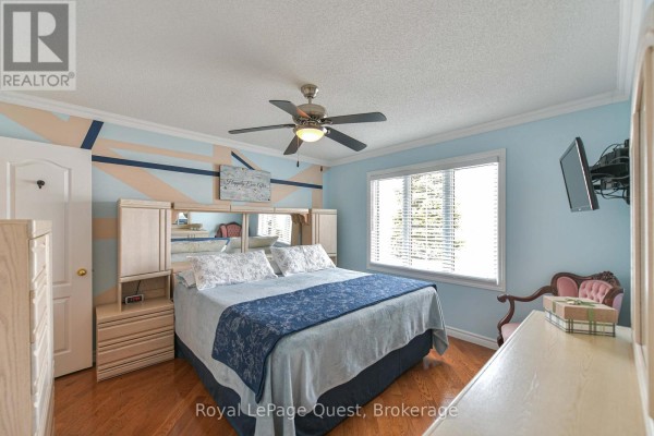 Back view of the home featuring a large deck and surrounding snow-covered yard. - 4662 Zachary Crescent, Ramara