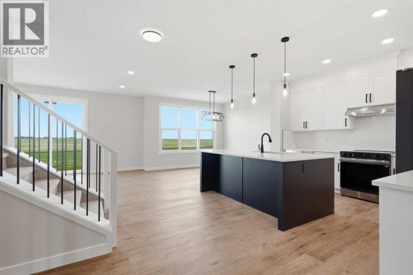 Bright entryway featuring a modern front door and large window - 467 Kinniburgh Loop, Chestermere