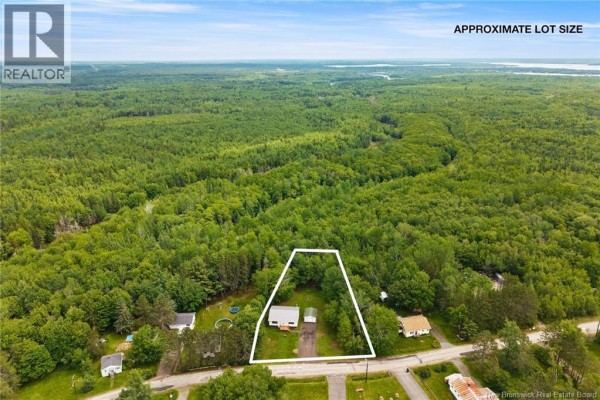 Aerial view showing the property's approximate lot size outlined in white, surrounded by dense forest. - 469 Upton St, Minto