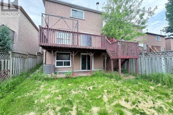 View of the backyard with a wooden deck, sliding glass doors, air conditioning unit, and fenced perimeter. - Bsmt - 47 Hewitt Crescent, Ajax