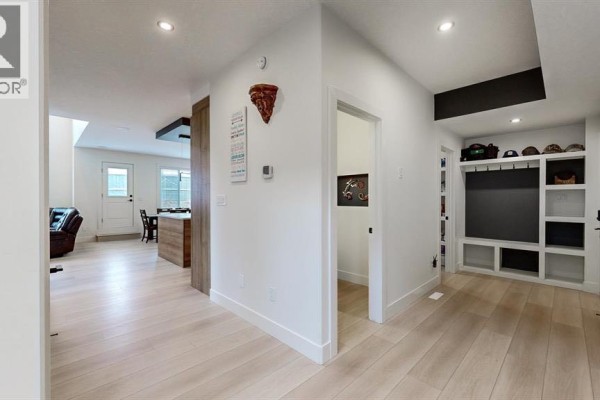 Primary bedroom with king-size bed, dresser, TV, and vaulted ceiling with dark beams. - 47 Hull Wynd, Spruce Grove