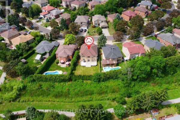 Aerial view of the neighborhood with multiple houses, green spaces, and swimming pools. - 47 Topham Crescent, Richmond Hill