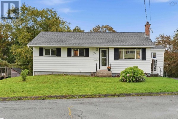 Exterior of a white split-level house with a green lawn and trees. - 47 Weyburn Road, Woodlawn