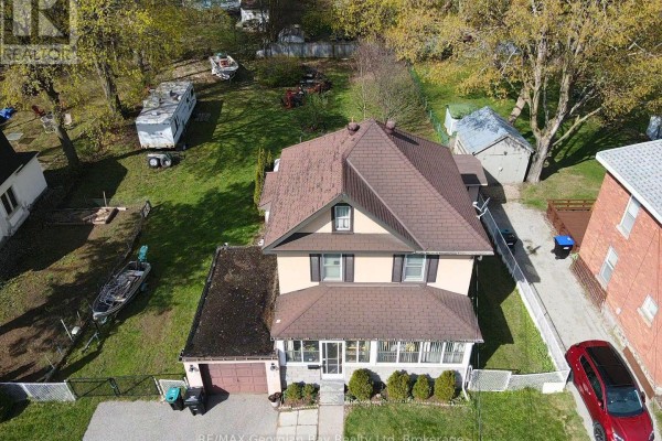 House with attached garage, boat, RV, and red car - 470 Manly Street Midland