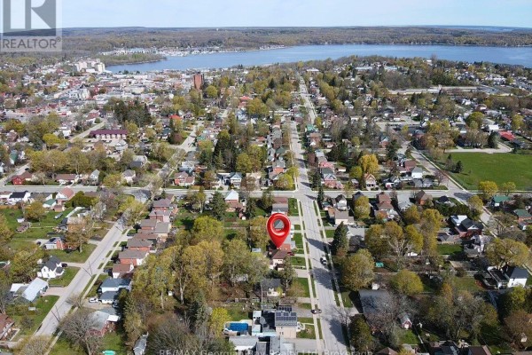 Aerial neighborhood view with houses, trees, and water - 470 Manly Street Midland