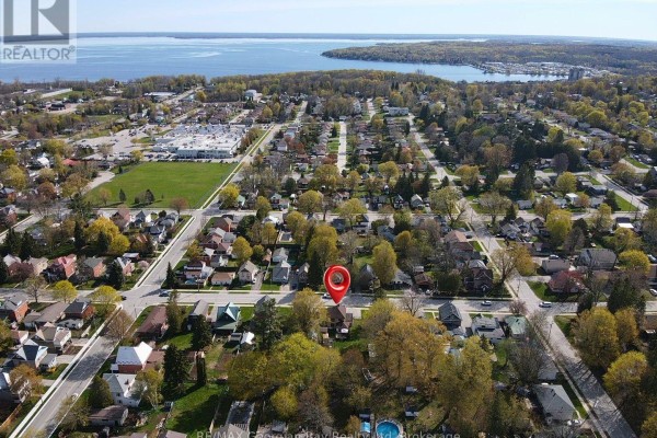 Aerial view of suburban neighborhood with pool and water in distance - 470 Manly Street Midland