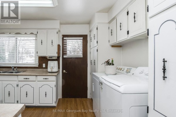 Laundry area with white cabinets and appliances - 470 Manly Street Midland