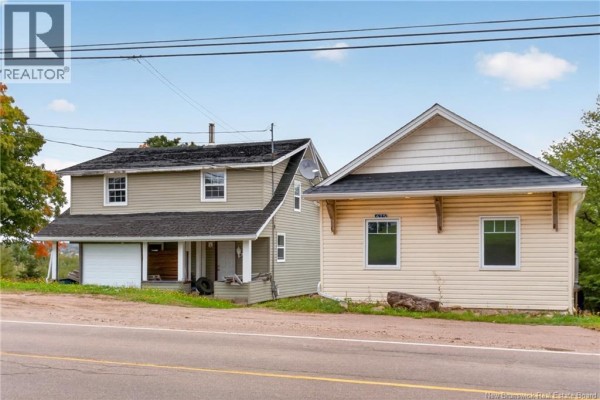 Two attached residential buildings with beige siding and white trim, viewed from the street. - 471 & 475 Centrale, Memramcook