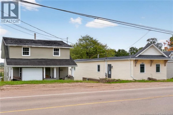 Two residential buildings and a driveway, viewed from the street, with trees and a blue sky in the background. - 471 & 475 Centrale, Memramcook