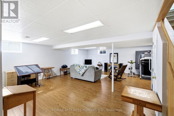 Finished basement with sofa, treadmill, exercise bike, and wooden floors - 4720 O'keefe Road South Stormont