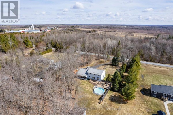 House with deck and pool, surrounded by trees, rural landscape. - 4720 O'keefe Road South Stormont