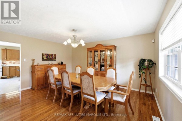 Wooden dining table with upholstered chairs, china cabinet, buffet, hardwood floors - 4720 O'keefe Road South Stormont