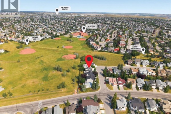 Aerial view of a Calgary neighborhood showing houses, parks, schools, and shopping. - 473 Hawkford Way Nw, Calgary