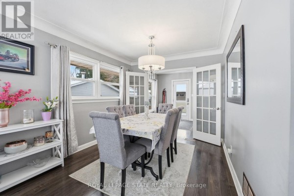 Brick and stone house with large windows and front porch - 473 Mohawk Road W Hamilton