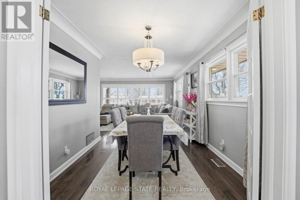 Bedroom with white dressers, mirrored art, closet, and desk - 473 Mohawk Road W Hamilton