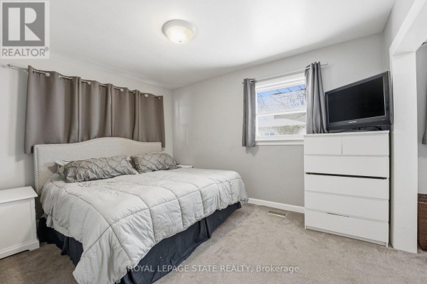 Backyard with lawn, hot tub, detached garage and sheds - 473 Mohawk Road W Hamilton