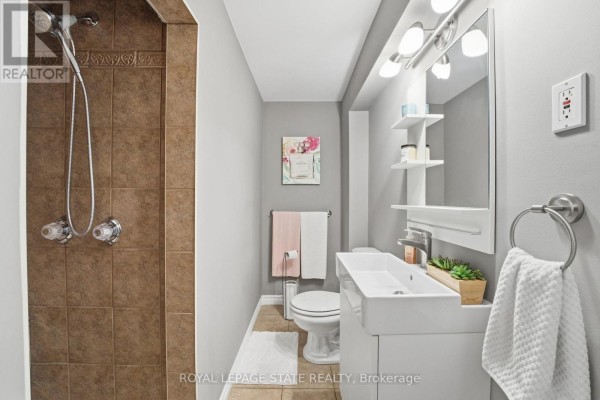 Bedroom with tufted comforter bed, mirrored closet, shelving - 473 Mohawk Road W Hamilton