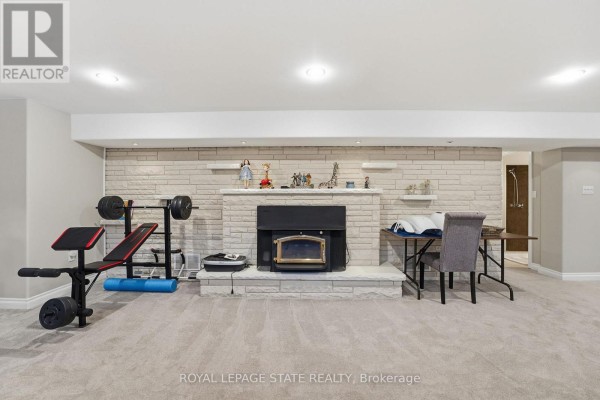 Modern kitchen with white cabinets, stainless steel appliances, and subway tile backsplash - 473 Mohawk Road W Hamilton
