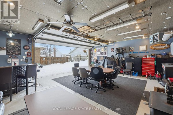 Aerial view of house with garage, patio, lawn and mature trees - 473 Mohawk Road W Hamilton