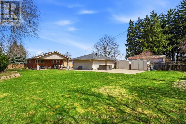 Finished basement with treadmill, fireplace, desk, and chair - 473 Mohawk Road W Hamilton