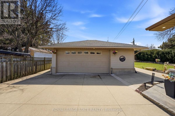 Finished basement with fireplace, weight bench, and desk - 473 Mohawk Road W Hamilton