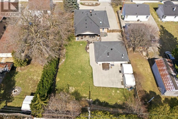 Backyard with hot tub, storage sheds, and patio - 473 Mohawk Road W Hamilton