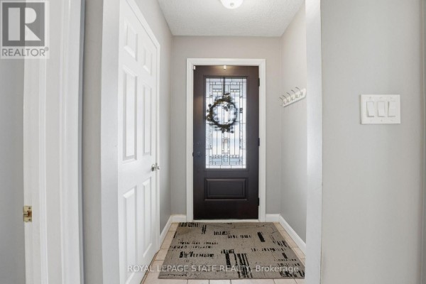 Modern kitchen with white cabinets, granite counters, and stainless steel appliances - 473 Mohawk Road W Hamilton