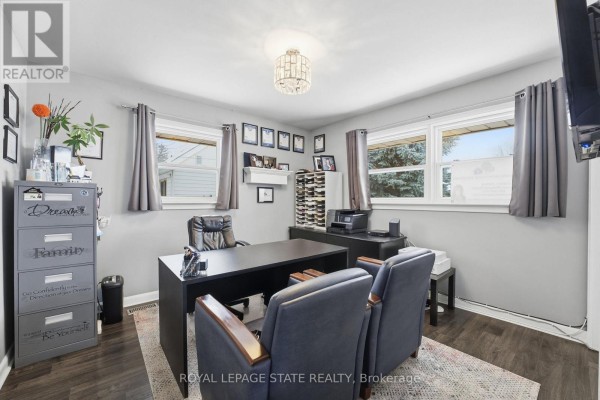 Bedroom with TV, dresser, mirror, and adjoining room - 473 Mohawk Road W Hamilton