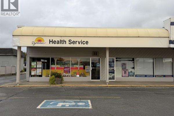 Close-up of "Dynamic Health Service" storefront with large windows and signage. - 4736 Lakelse Avenue, Terrace